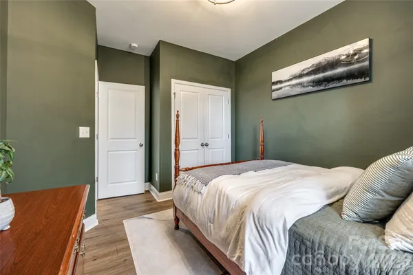 a bedroom with beds and a night stand
