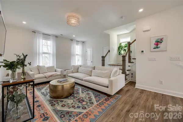 a living room with furniture and a potted plant