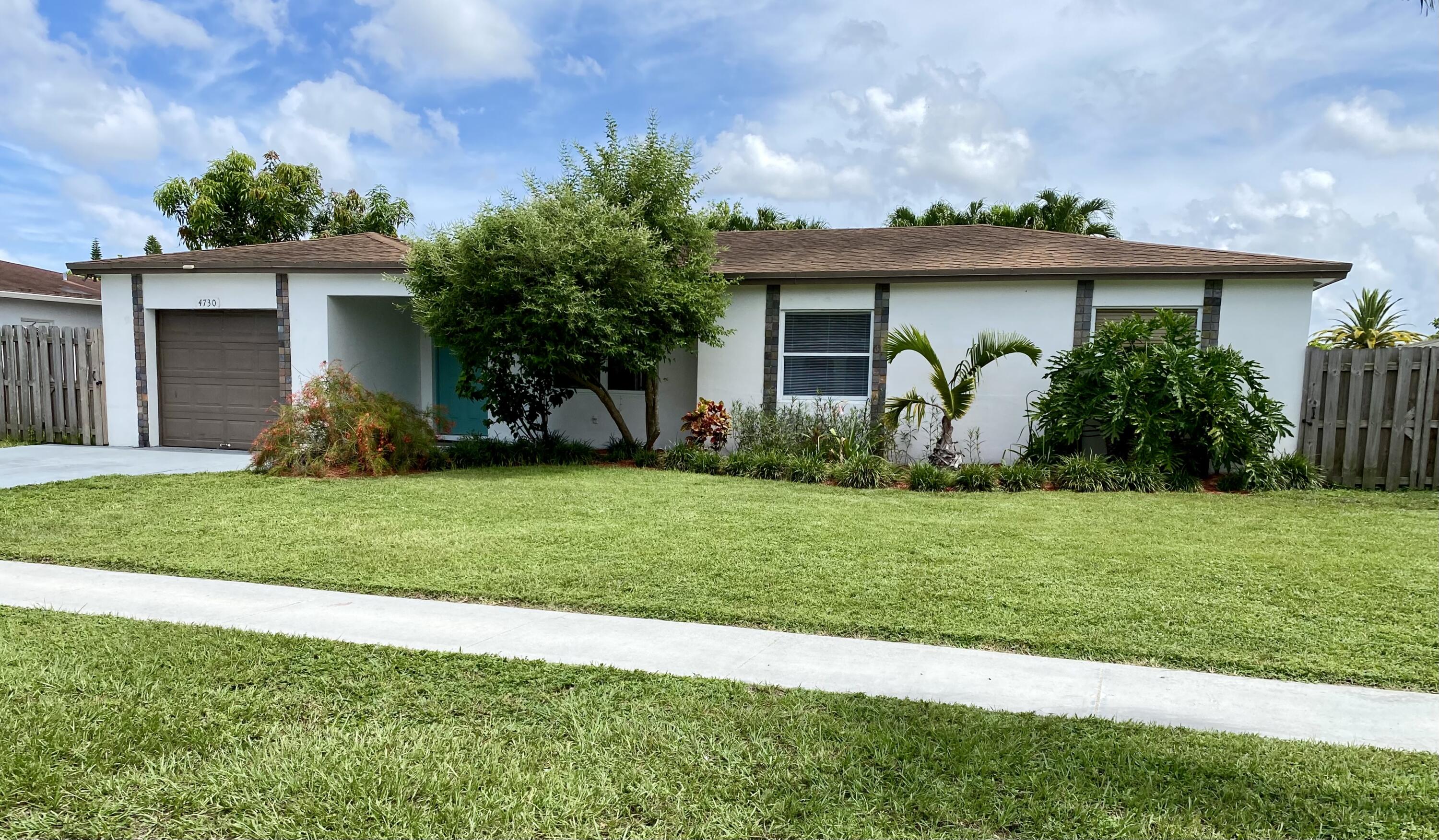 4730 Betelnut Street Boca Raton, FL 33428 - Photo 1 of 42 a front view of a house with garden