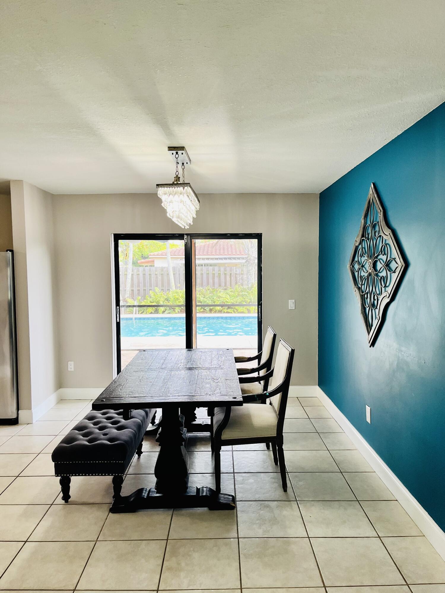 4730 Betelnut Street Boca Raton, FL 33428 - Photo 11 of 42 a view of a dining room with furniture and a chandelier