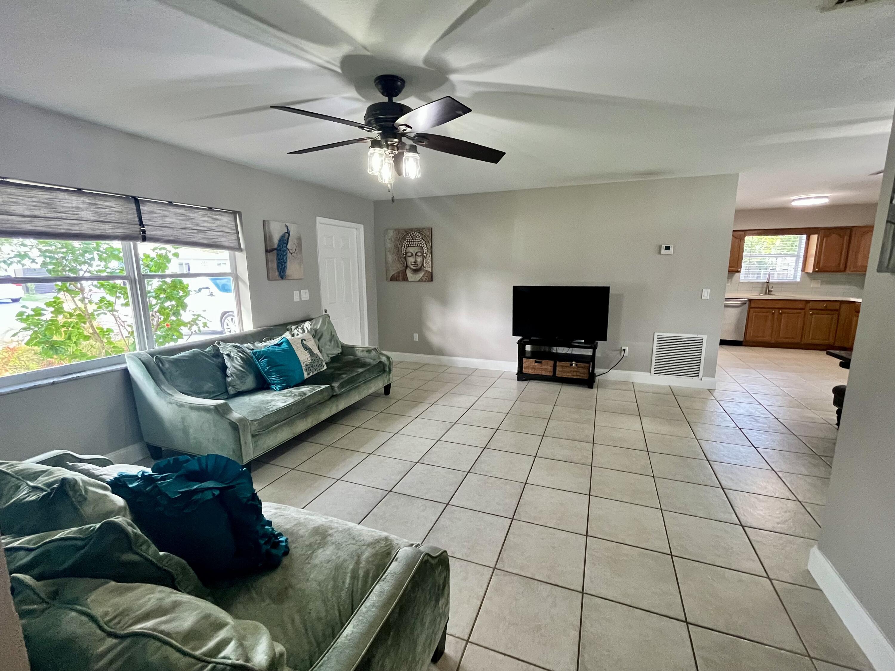 4730 Betelnut Street Boca Raton, FL 33428 - Photo 15 of 42 a living room with couches and a flat screen tv