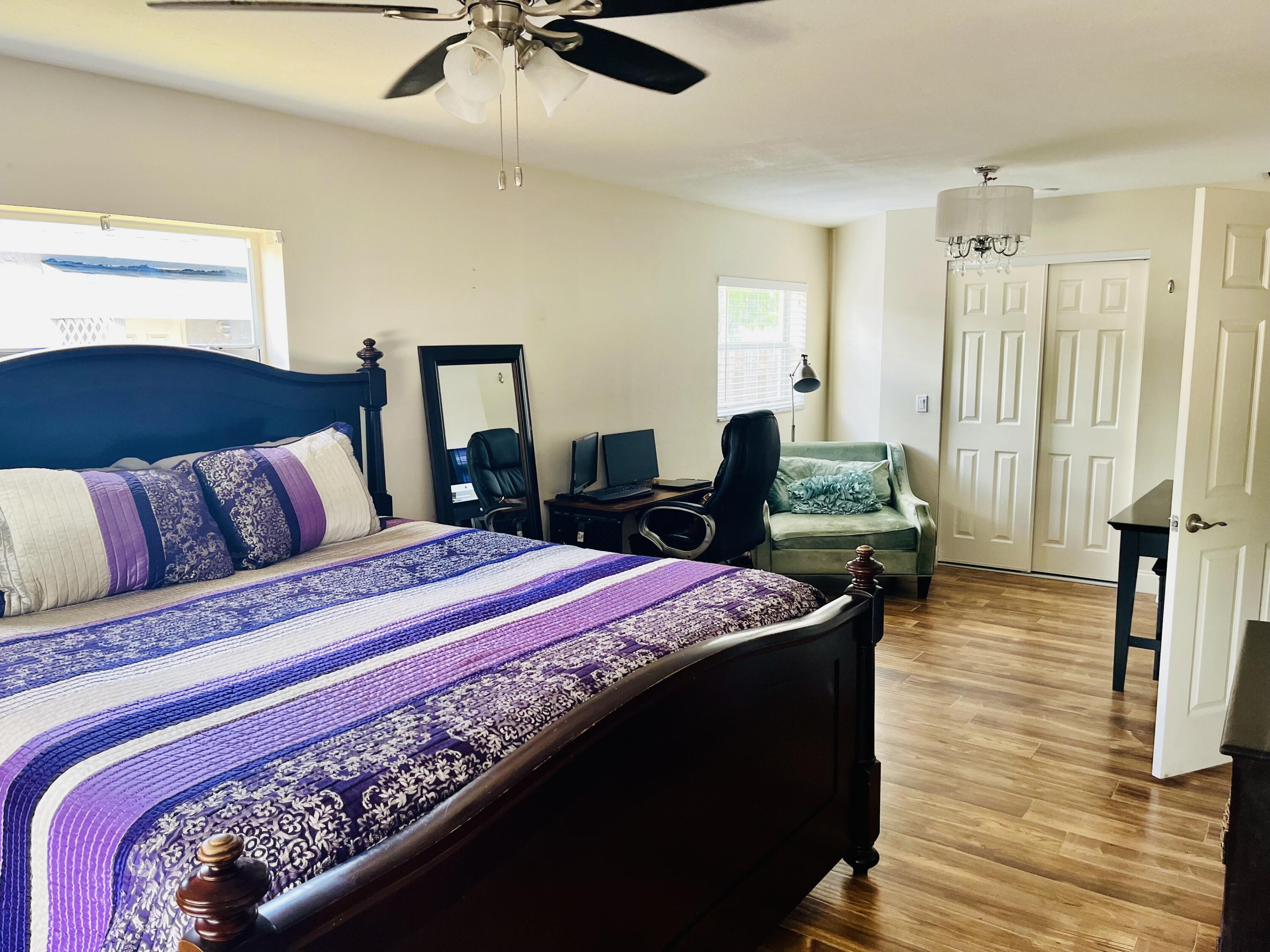 4730 Betelnut Street Boca Raton, FL 33428 - Photo 16 of 42 a bedroom with bed and wooden floor
