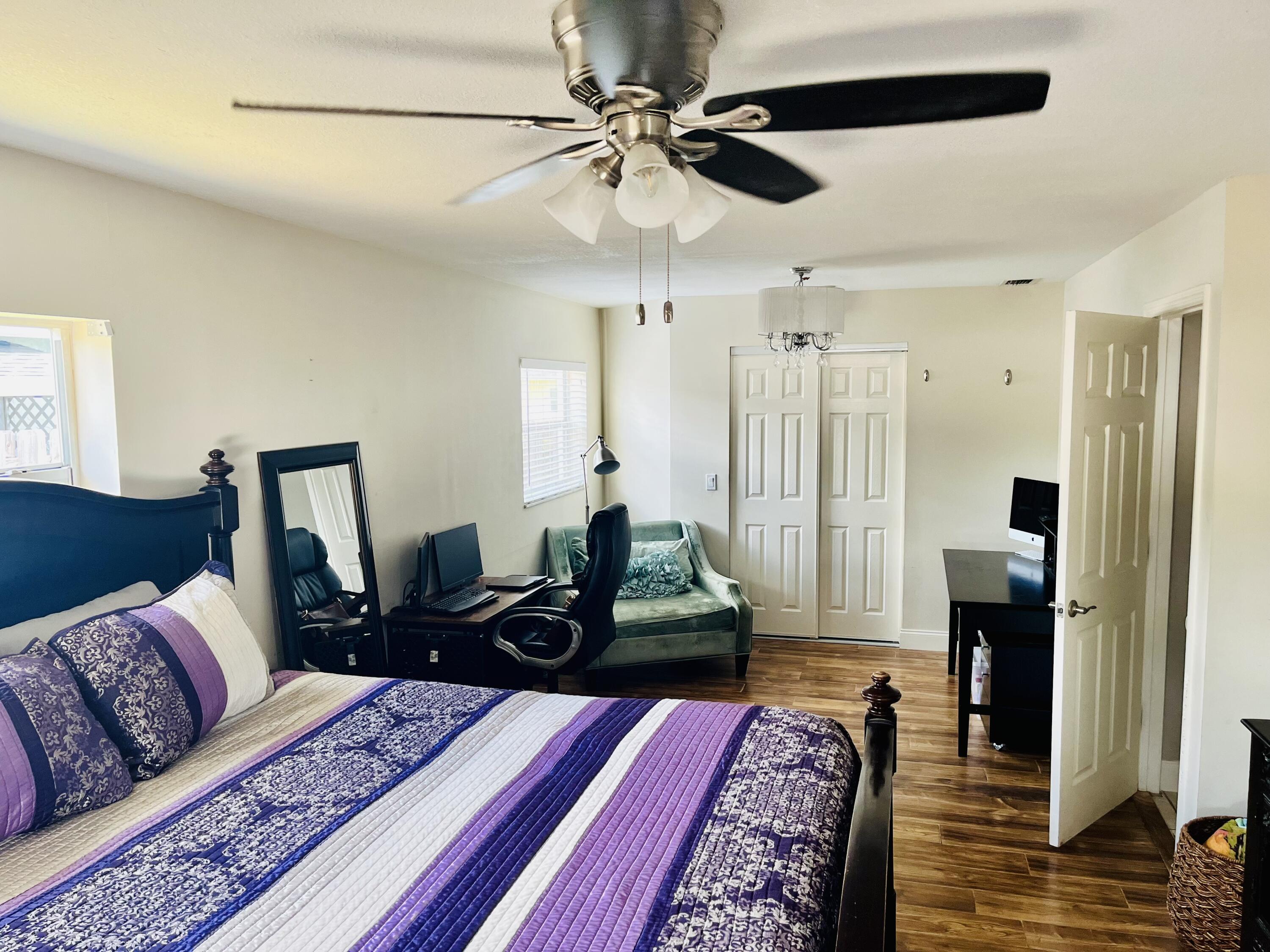 4730 Betelnut Street Boca Raton, FL 33428 - Photo 17 of 42 a bedroom with furniture and wooden floor