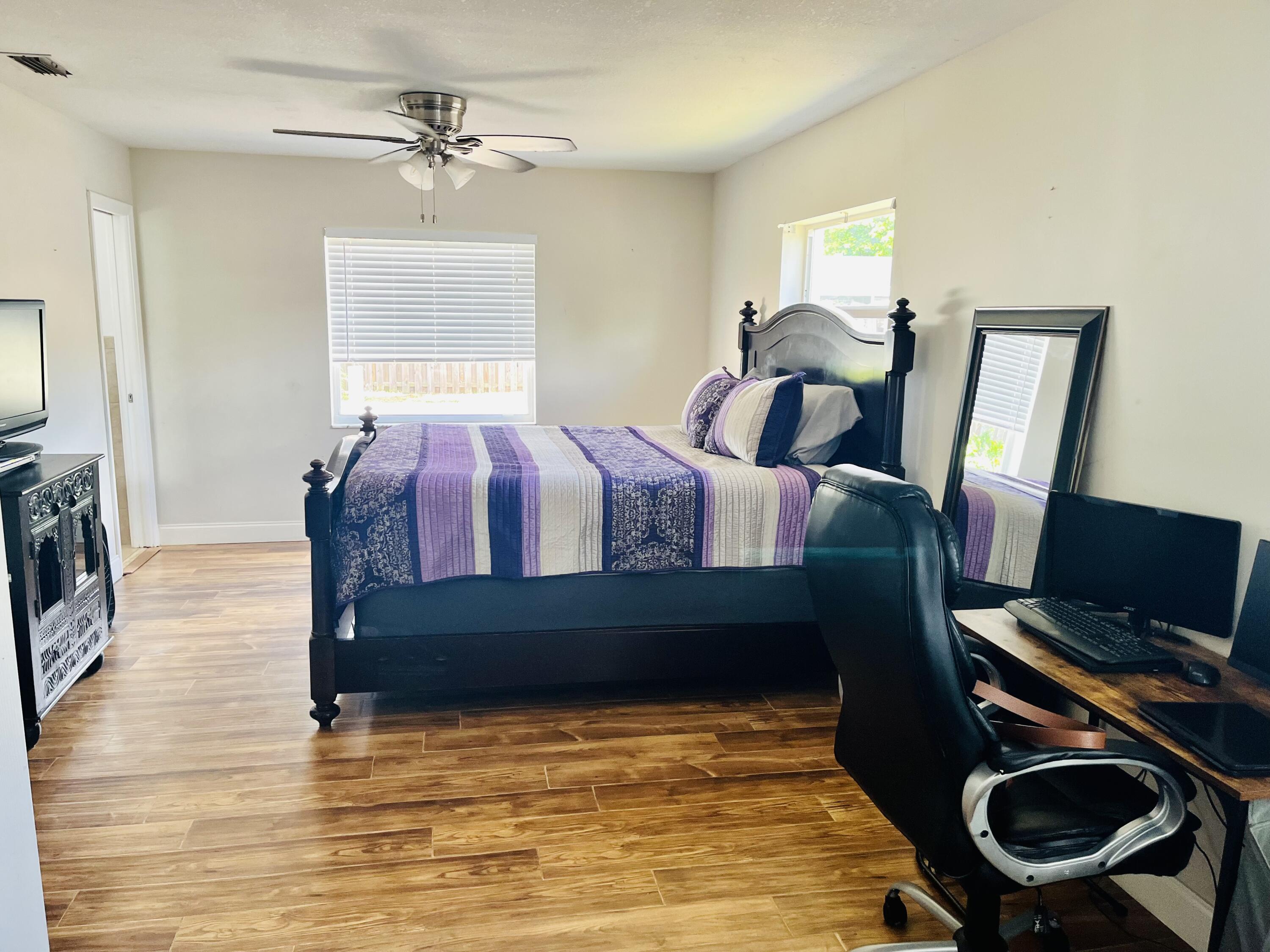 4730 Betelnut Street Boca Raton, FL 33428 - Photo 18 of 42 a bedroom with furniture and a window