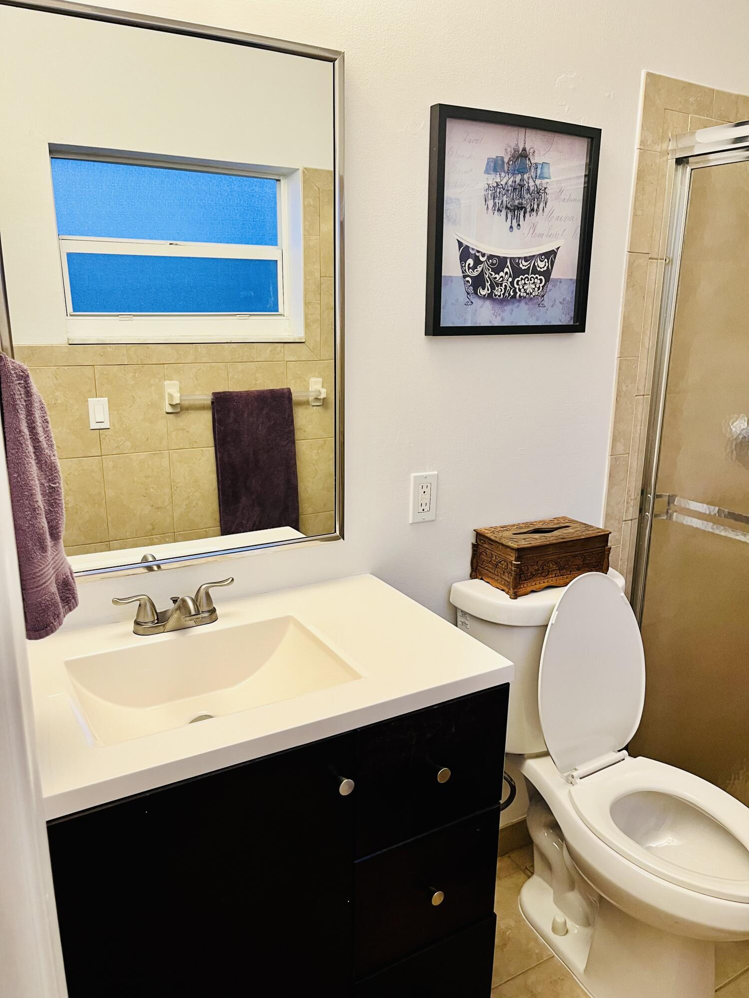 4730 Betelnut Street Boca Raton, FL 33428 - Photo 19 of 42 a bathroom with a toilet sink and mirror
