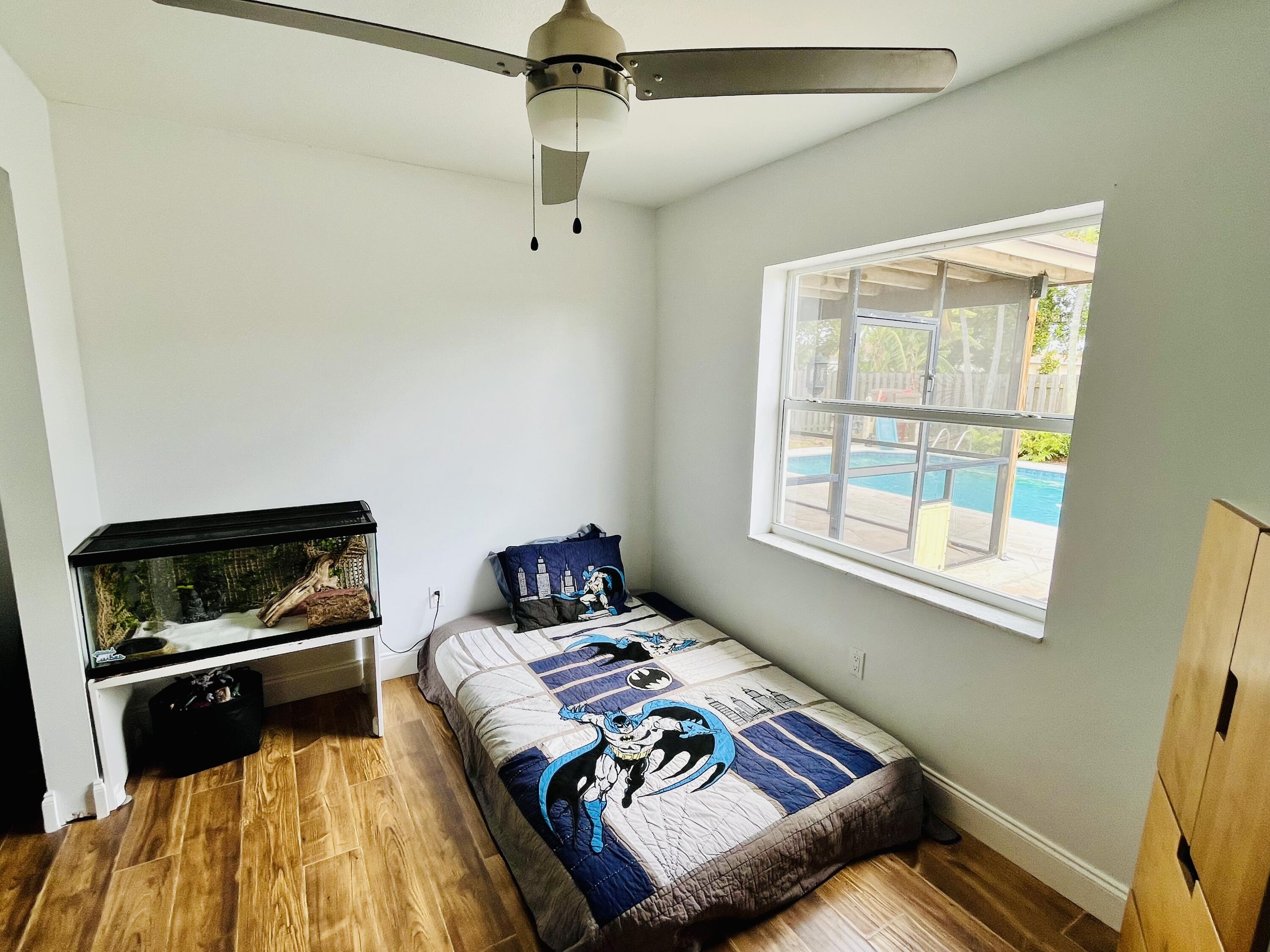 4730 Betelnut Street Boca Raton, FL 33428 - Photo 24 of 42 a bed sitting in a bedroom next to a window