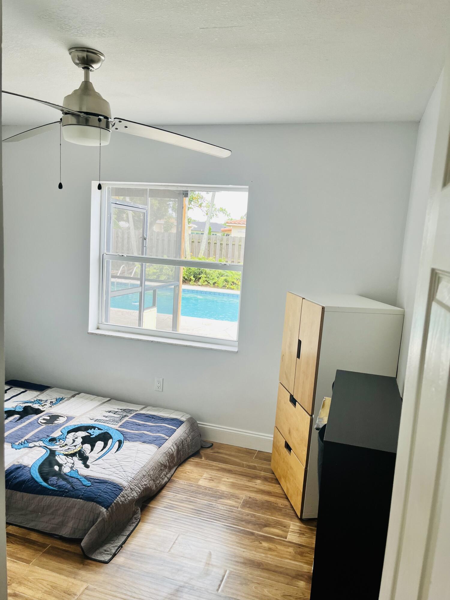 4730 Betelnut Street Boca Raton, FL 33428 - Photo 25 of 42 a bedroom with a bed and a window