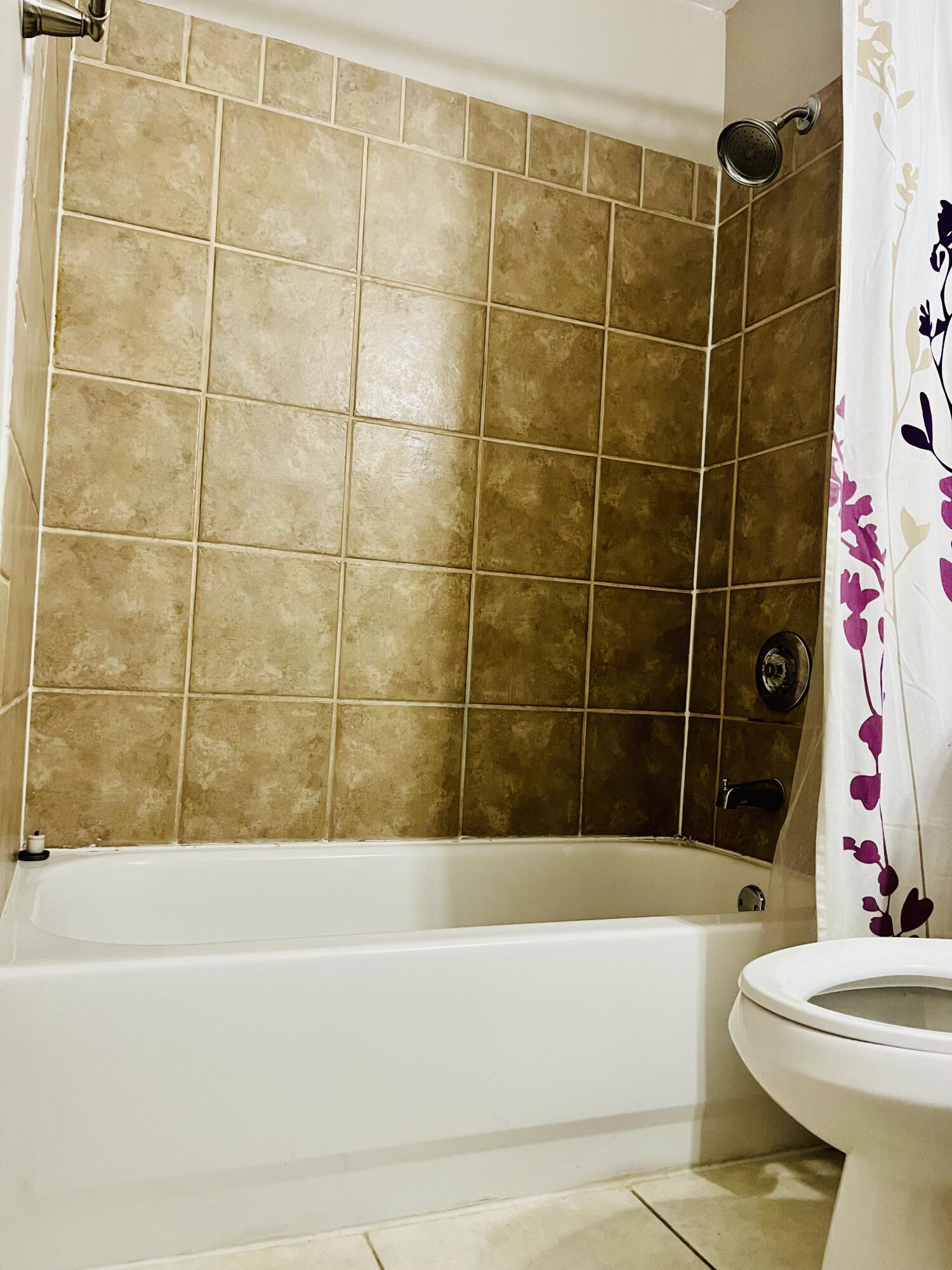 4730 Betelnut Street Boca Raton, FL 33428 - Photo 28 of 42 a bathroom with a bathtub and toilet