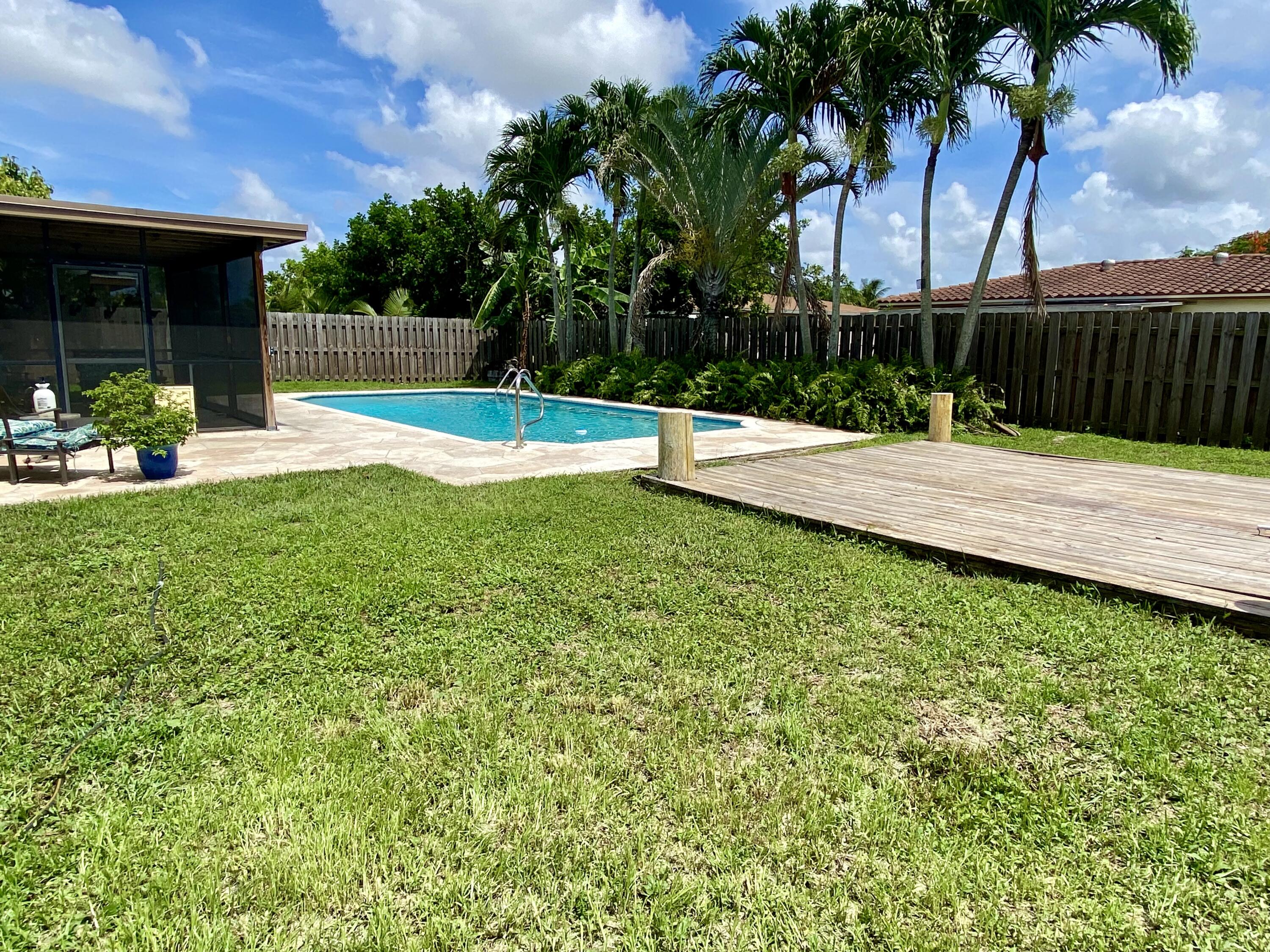 4730 Betelnut Street Boca Raton, FL 33428 - Photo 34 of 42 a view of a backyard with a slide
