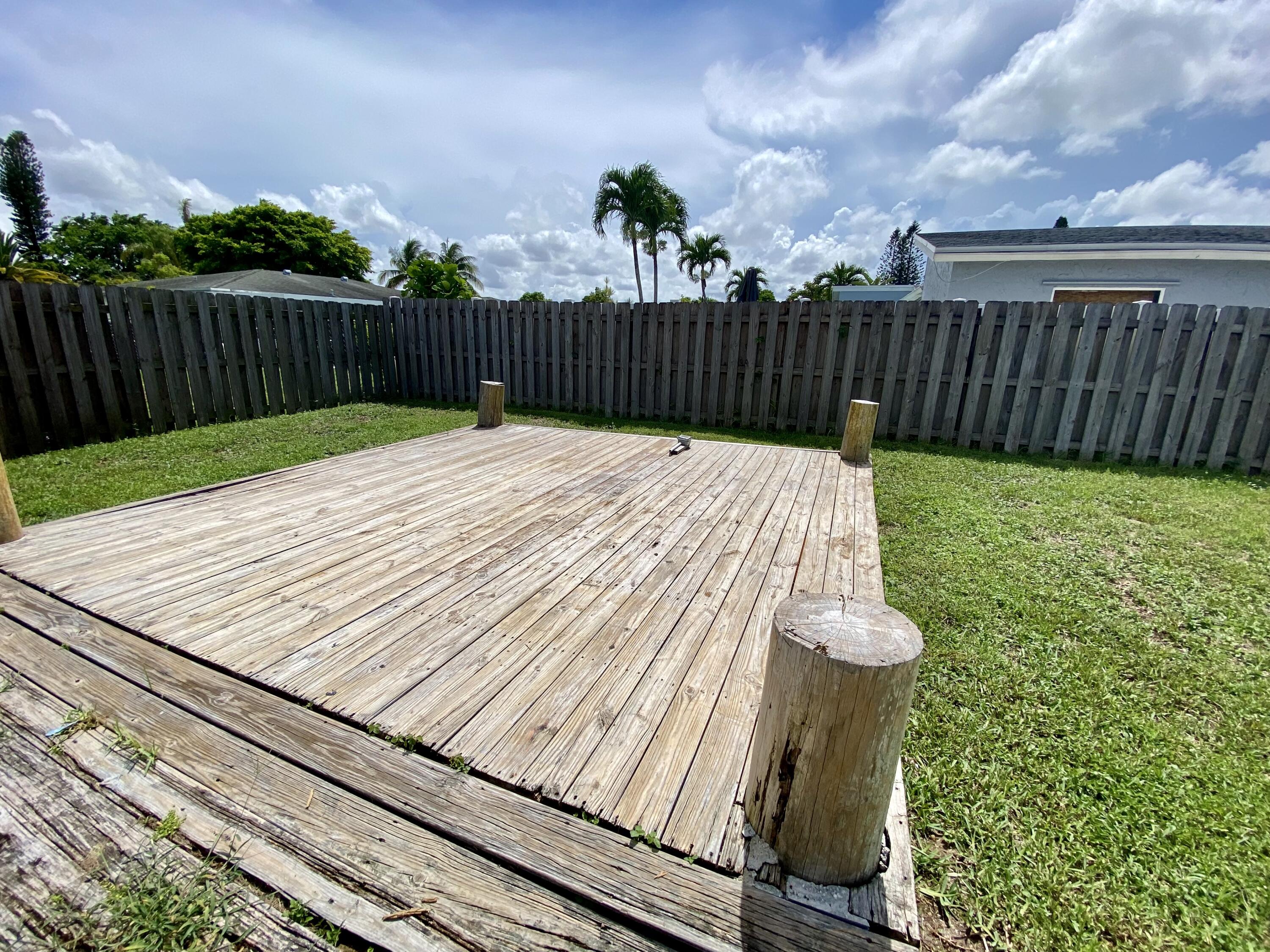 4730 Betelnut Street Boca Raton, FL 33428 - Photo 35 of 42 a view of a backyard with wooden fence