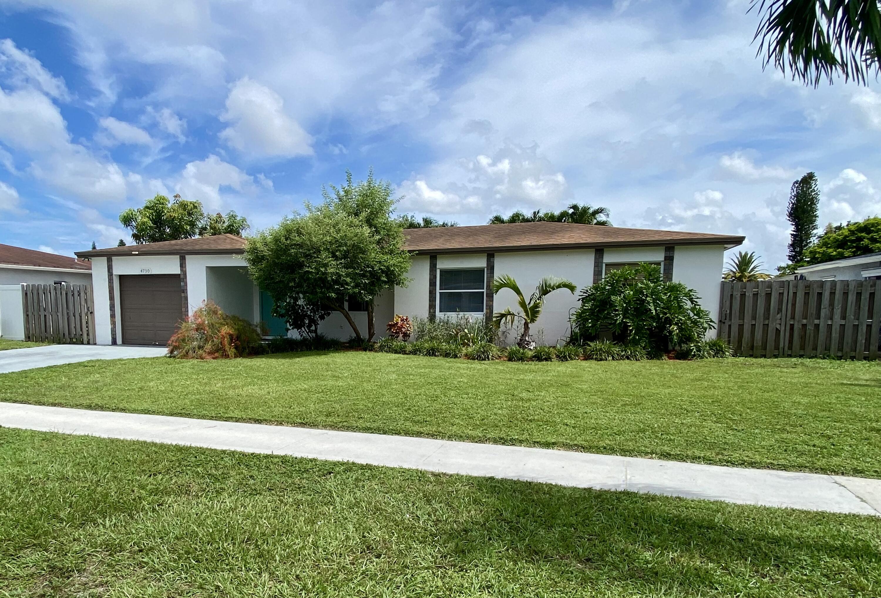 4730 Betelnut Street Boca Raton, FL 33428 - Photo 39 of 42 a front view of a house with a garden