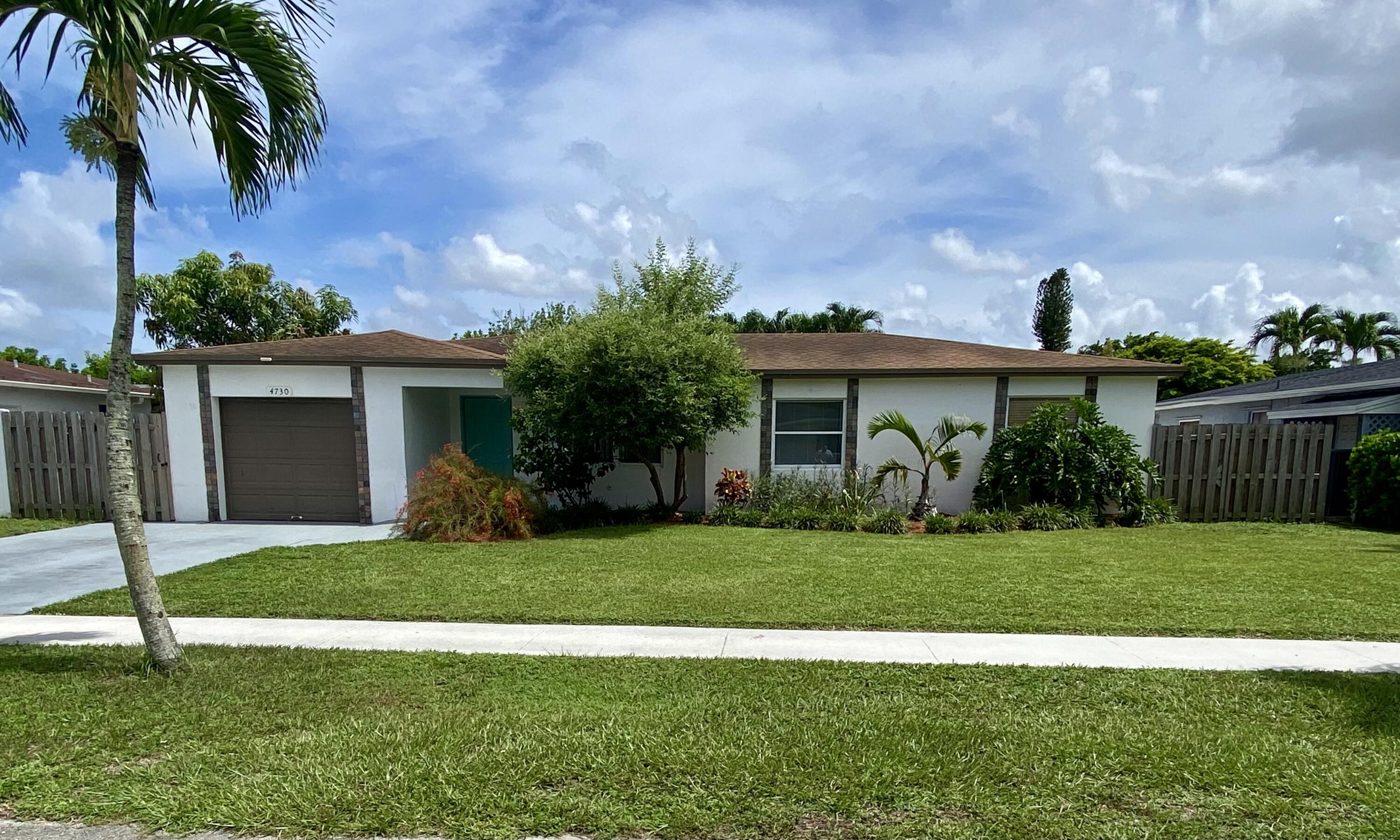 4730 Betelnut Street Boca Raton, FL 33428 - Photo 40 of 42 a front view of a house with a garden