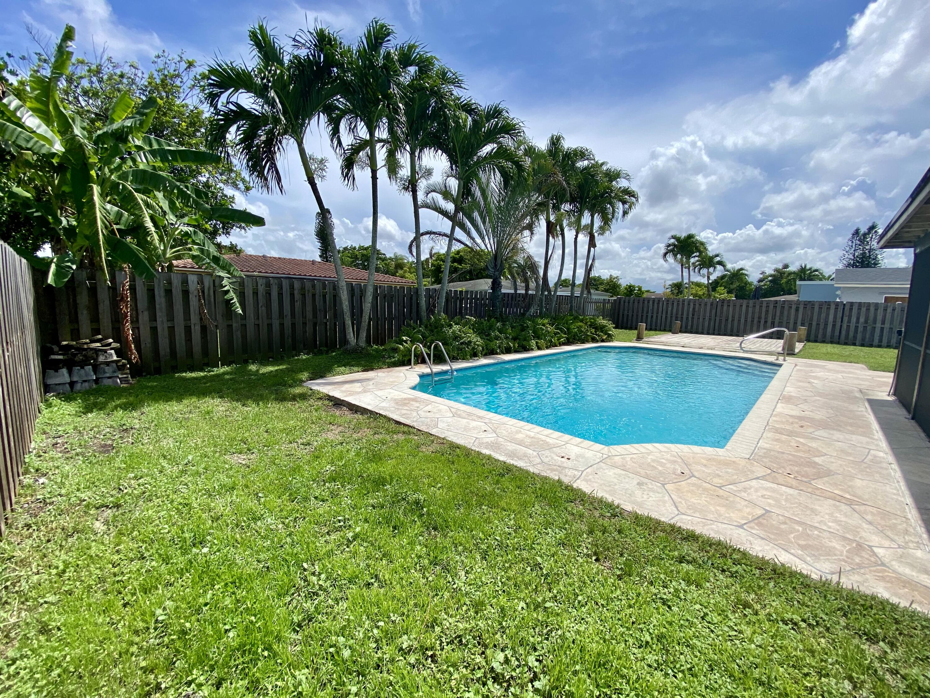 4730 Betelnut Street Boca Raton, FL 33428 - Photo 4 of 42 a view of swimming pool with a backyard