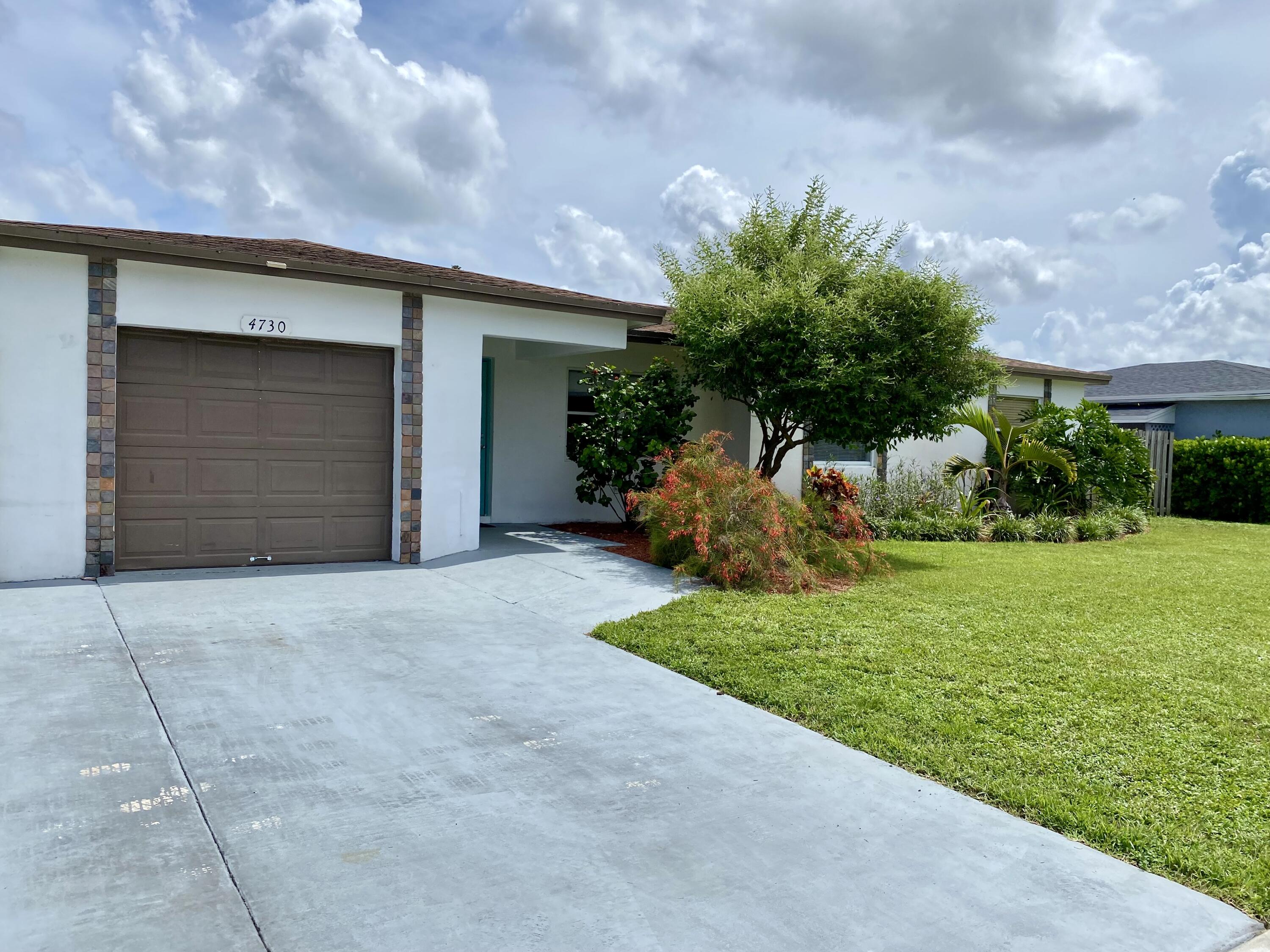 4730 Betelnut Street Boca Raton, FL 33428 - Photo 41 of 42 a house view with a garden space