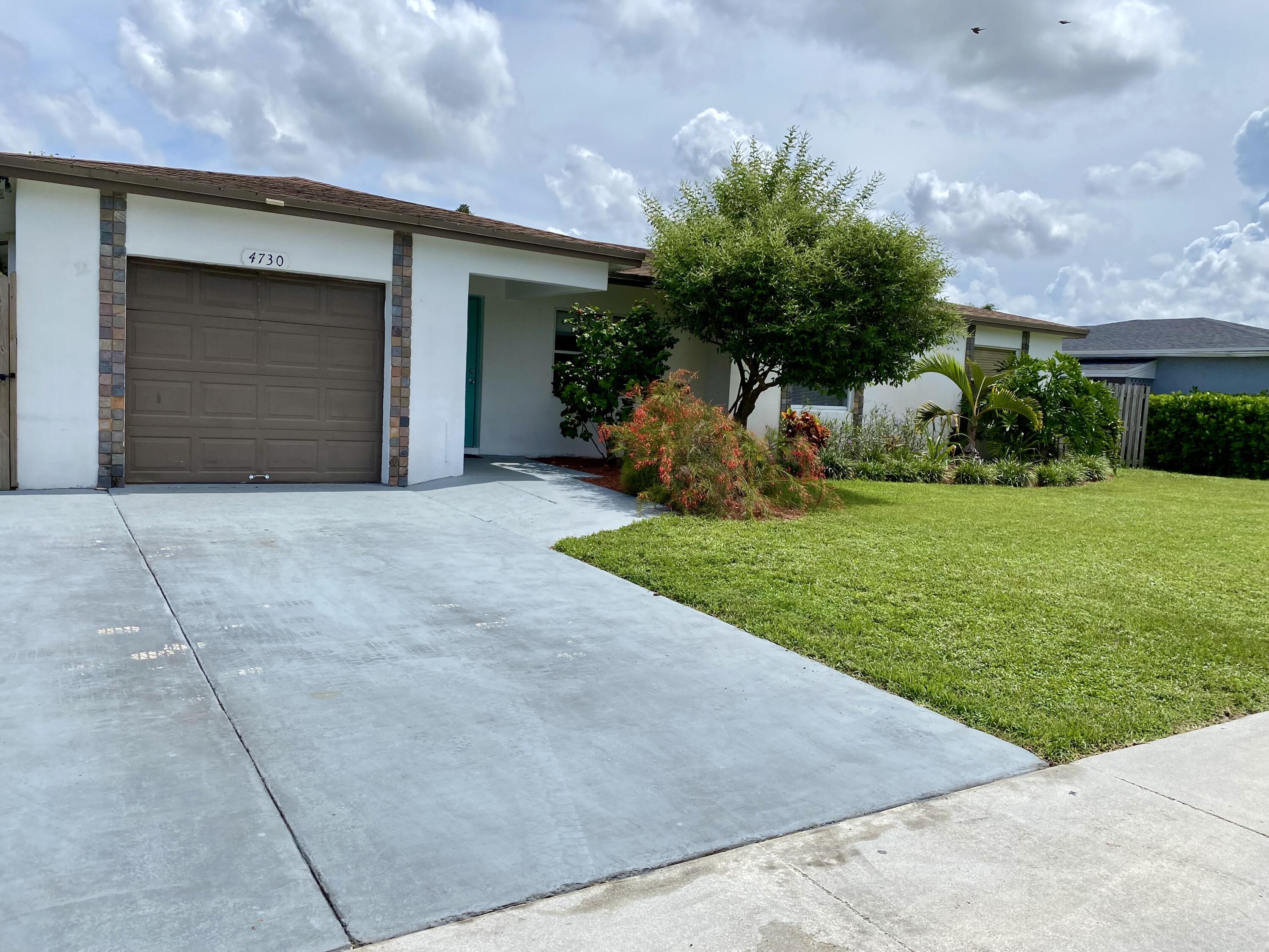4730 Betelnut Street Boca Raton, FL 33428 - Photo 42 of 42 a view of a house with backyard and porch