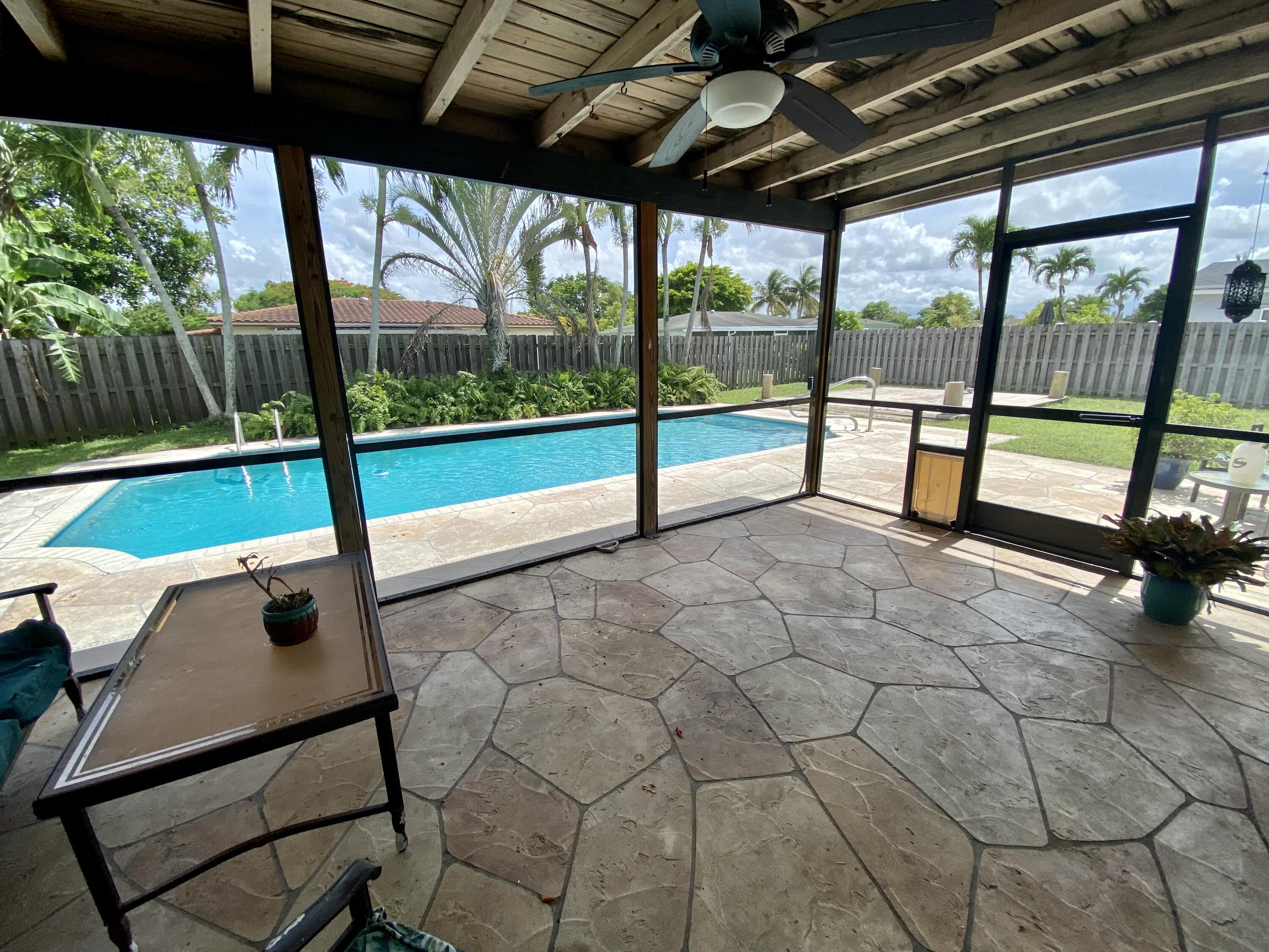 4730 Betelnut Street Boca Raton, FL 33428 - Photo 5 of 42 a view of a porch with furniture and garden