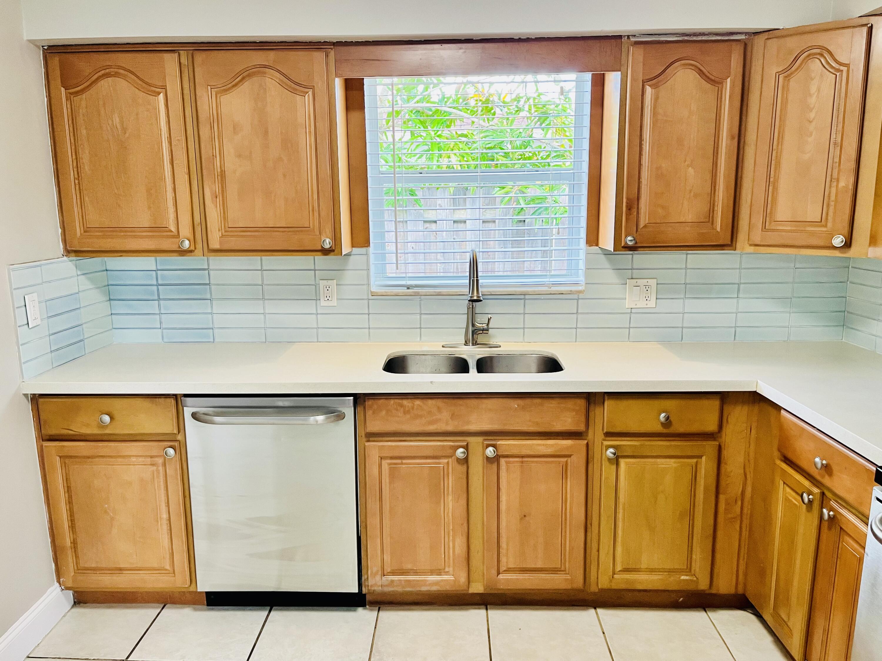 4730 Betelnut Street Boca Raton, FL 33428 - Photo 8 of 42 a kitchen with stainless steel appliances granite countertop a sink and a cabinets