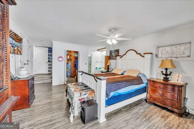 a bathroom with a granite countertop sink a toilet a mirror and shower