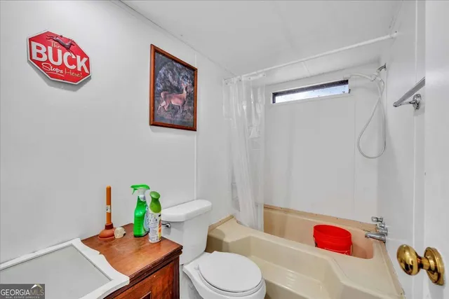 a kitchen with a refrigerator and a stove top oven