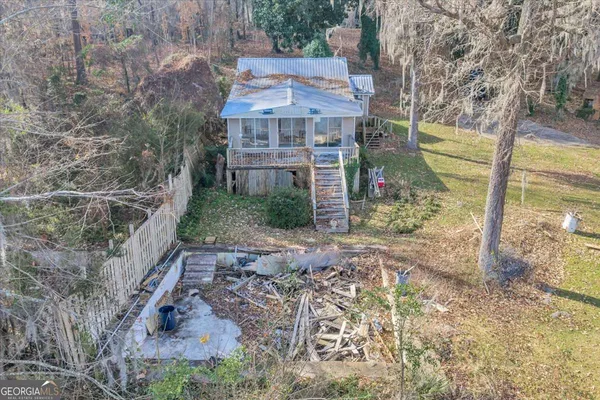 a view of house with backyard and balcony