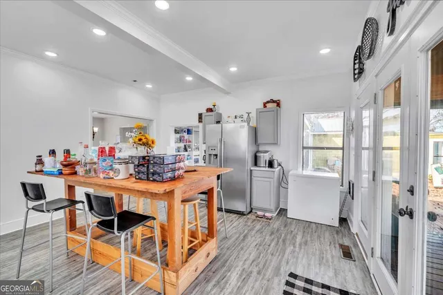 a living room with furniture a flat screen tv and a large window
