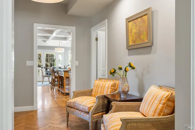 a kitchen with a stove a sink a dining table and chairs with wooden floor