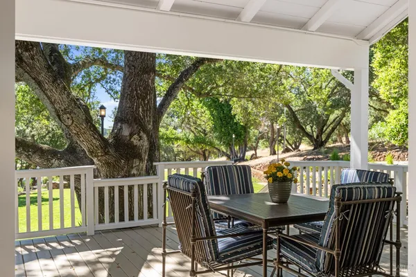 a view of a house with backyard and a tree
