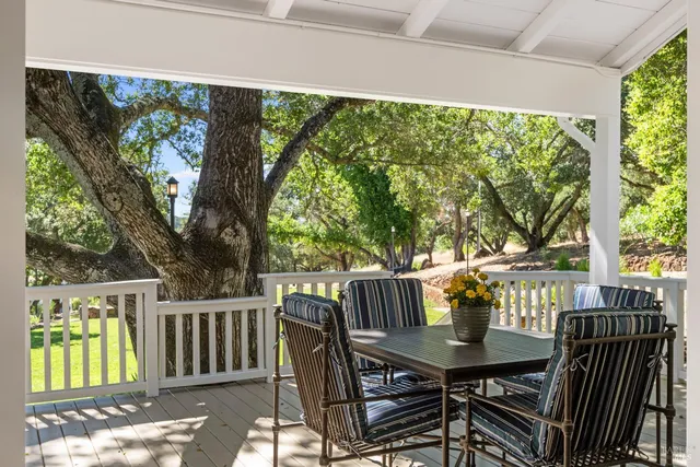 a view of a house with backyard and a tree