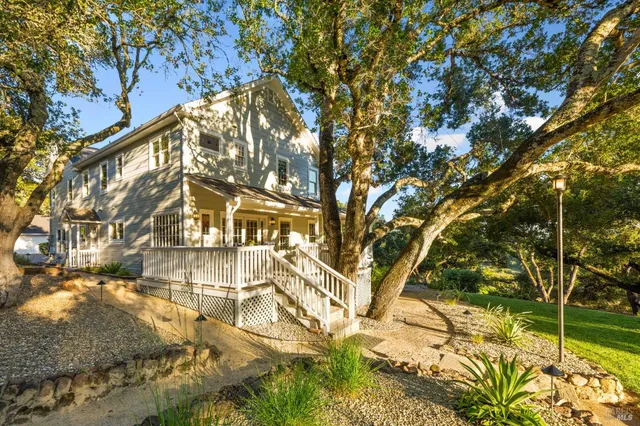 a view of a patio with a table chairs and backyard