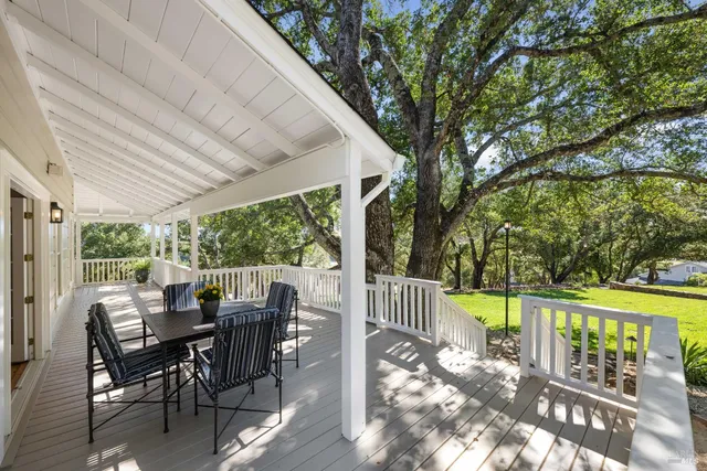 a view of a dining room with furniture a chandelier and wooden floor