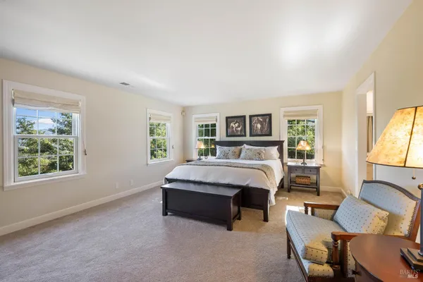 a bedroom with a bed and a mirror
