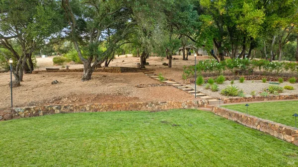 a front view of a house with a fountain