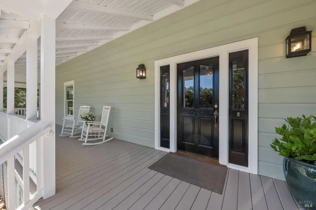 a living room with furniture and a dining table