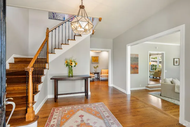 a living room with furniture and a fireplace with wooden floor