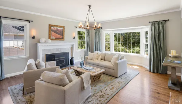 a living room with furniture a window and a chandelier