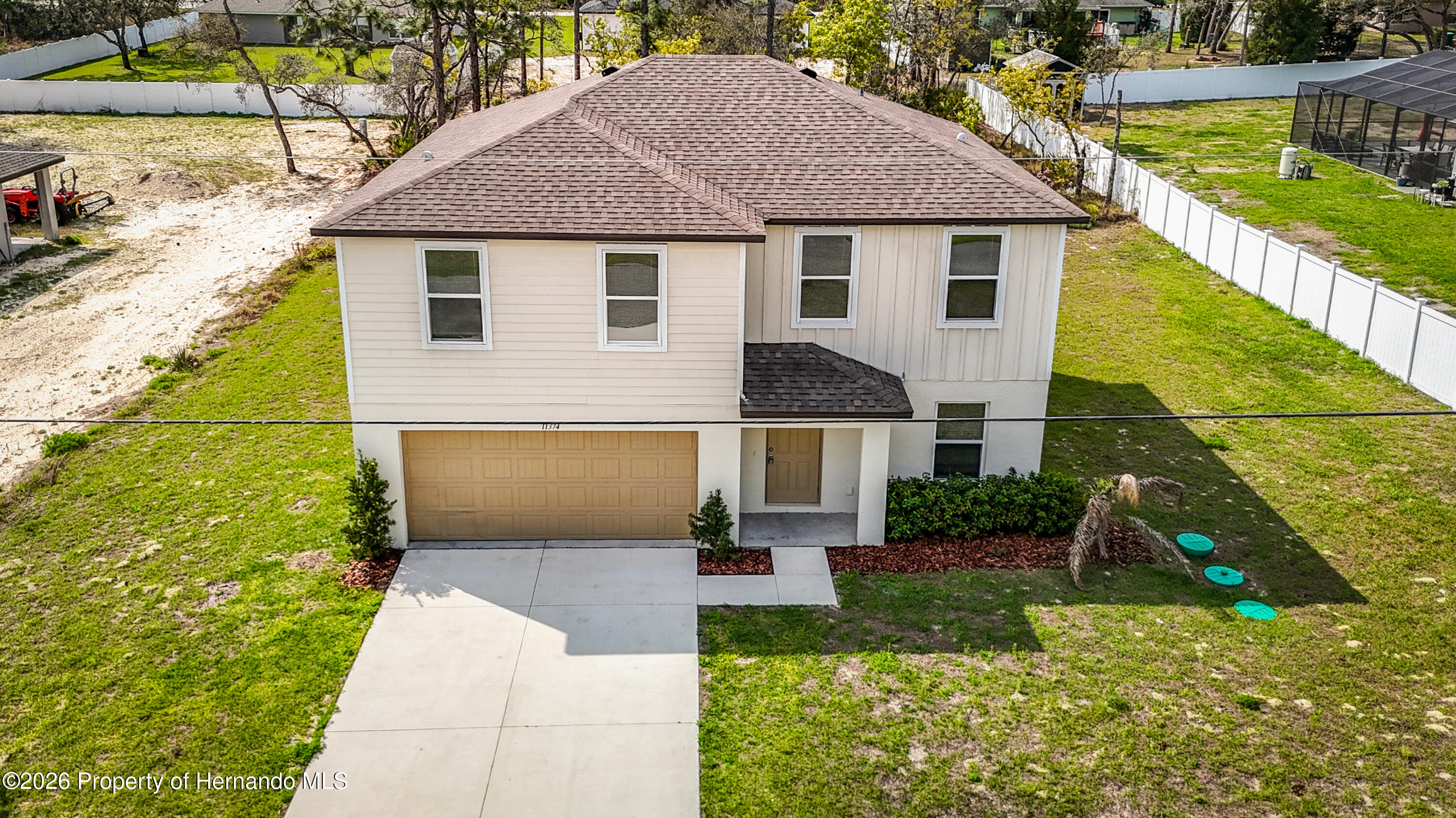 11374 Marcella Avenue Weeki Wachee, FL 34614 - Photo 4 of 70 a front view of a house with a yard