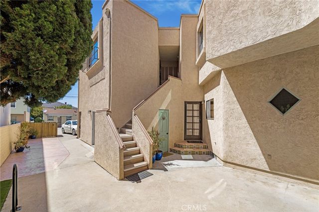 a view of a staircase with white walls and railing