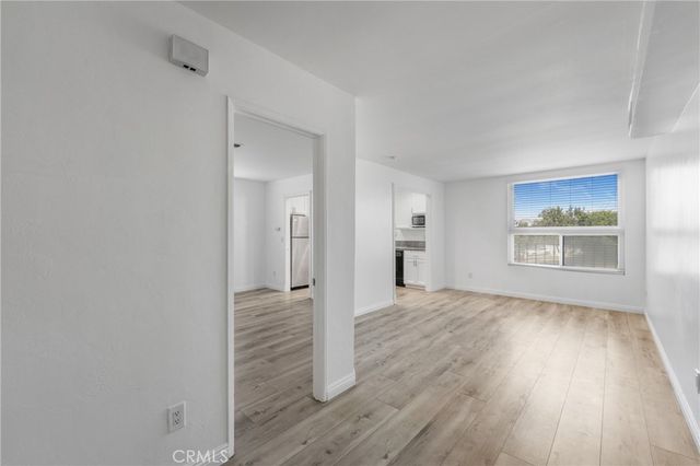 a view of hallway with wooden floor