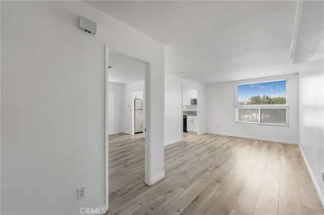 a view of hallway with wooden floor