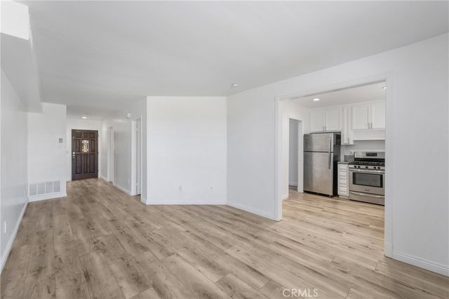 a view of a kitchen with a sink and a refrigerator