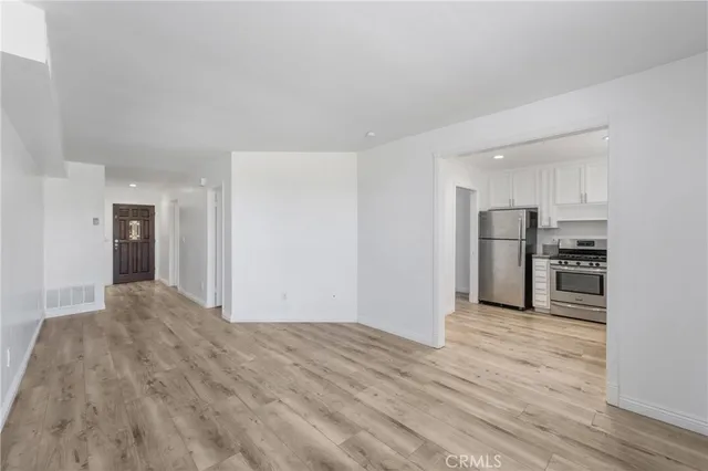 a view of a kitchen with a sink and a refrigerator