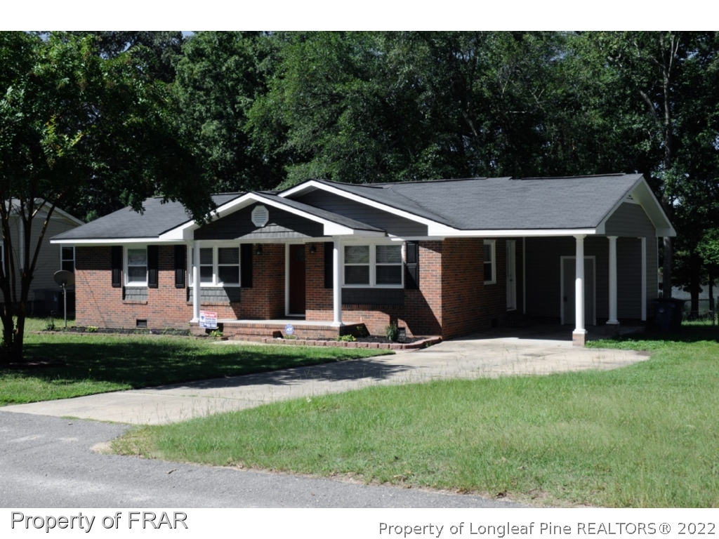 414 Lansdowne Road Fayetteville, NC 28314 - Photo 1 of 14 a front view of a house with a garden and porch