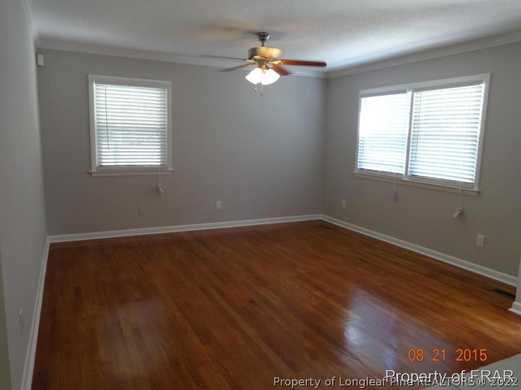 414 Lansdowne Road Fayetteville, NC 28314 - Photo 4 of 14 a view of an empty room with wooden floor and a window