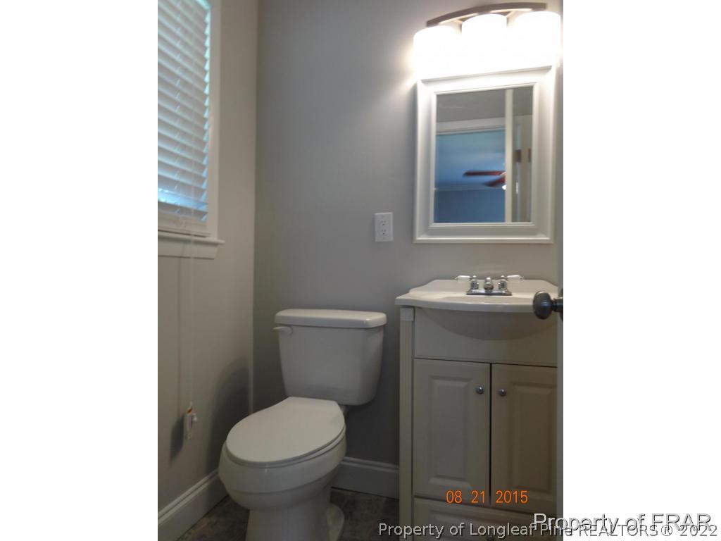 414 Lansdowne Road Fayetteville, NC 28314 - Photo 8 of 14 a bathroom with a sink toilet and mirror