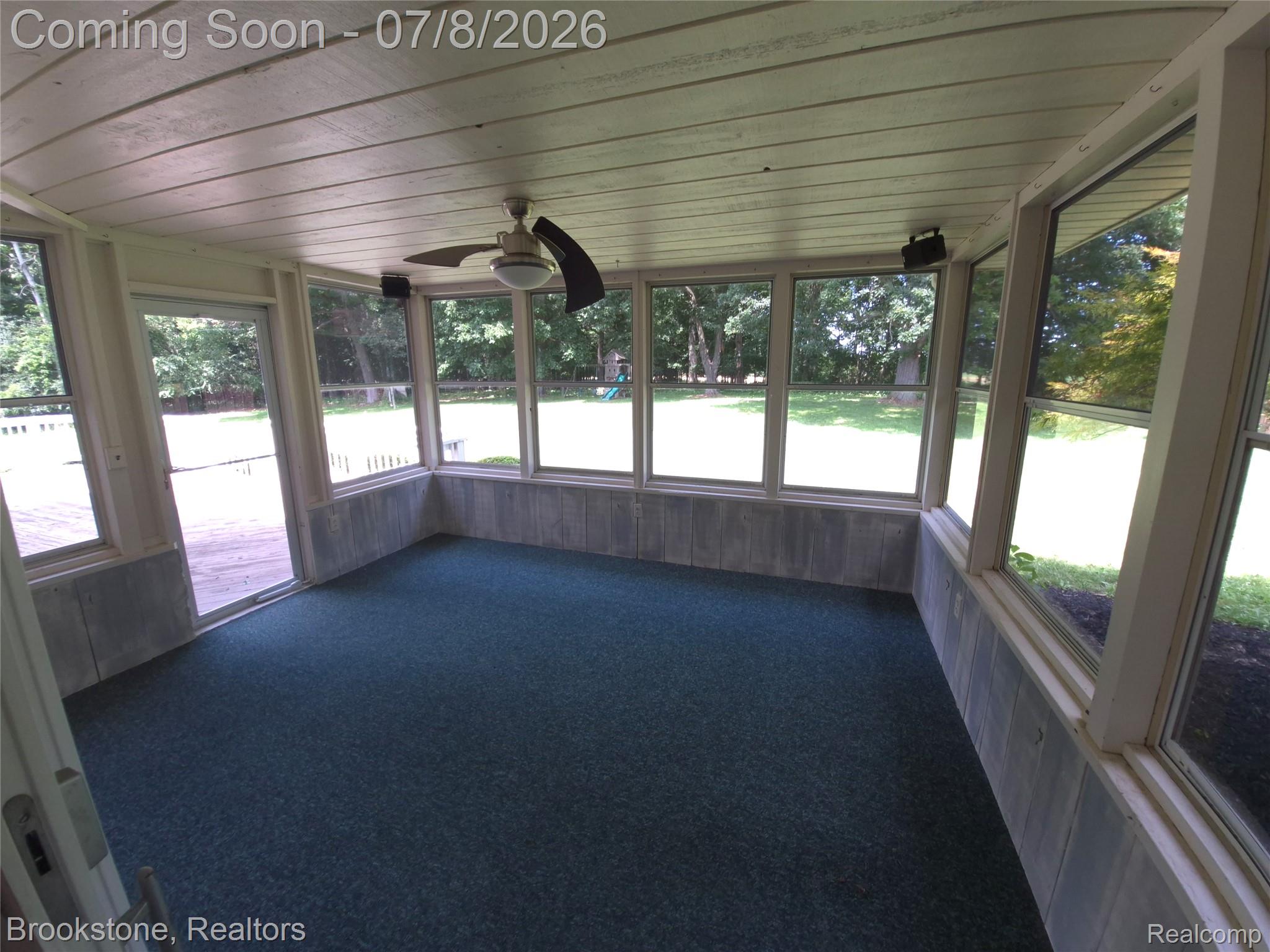 4140 South Henderson Road Davison, MI 48423 - Photo 95 of 98 Sunroom featuring wall-to-wall carpeting, extensive window panels, and a ceiling fan