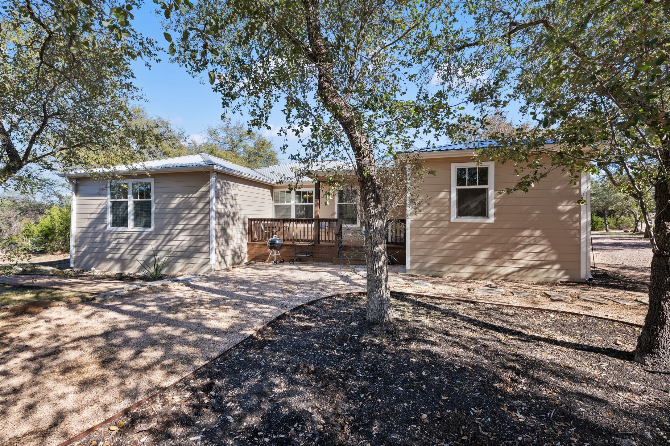 1610 Pace Bend Road North Spicewood, TX 78669 - Photo 26 of 32 a backyard of a house with large trees