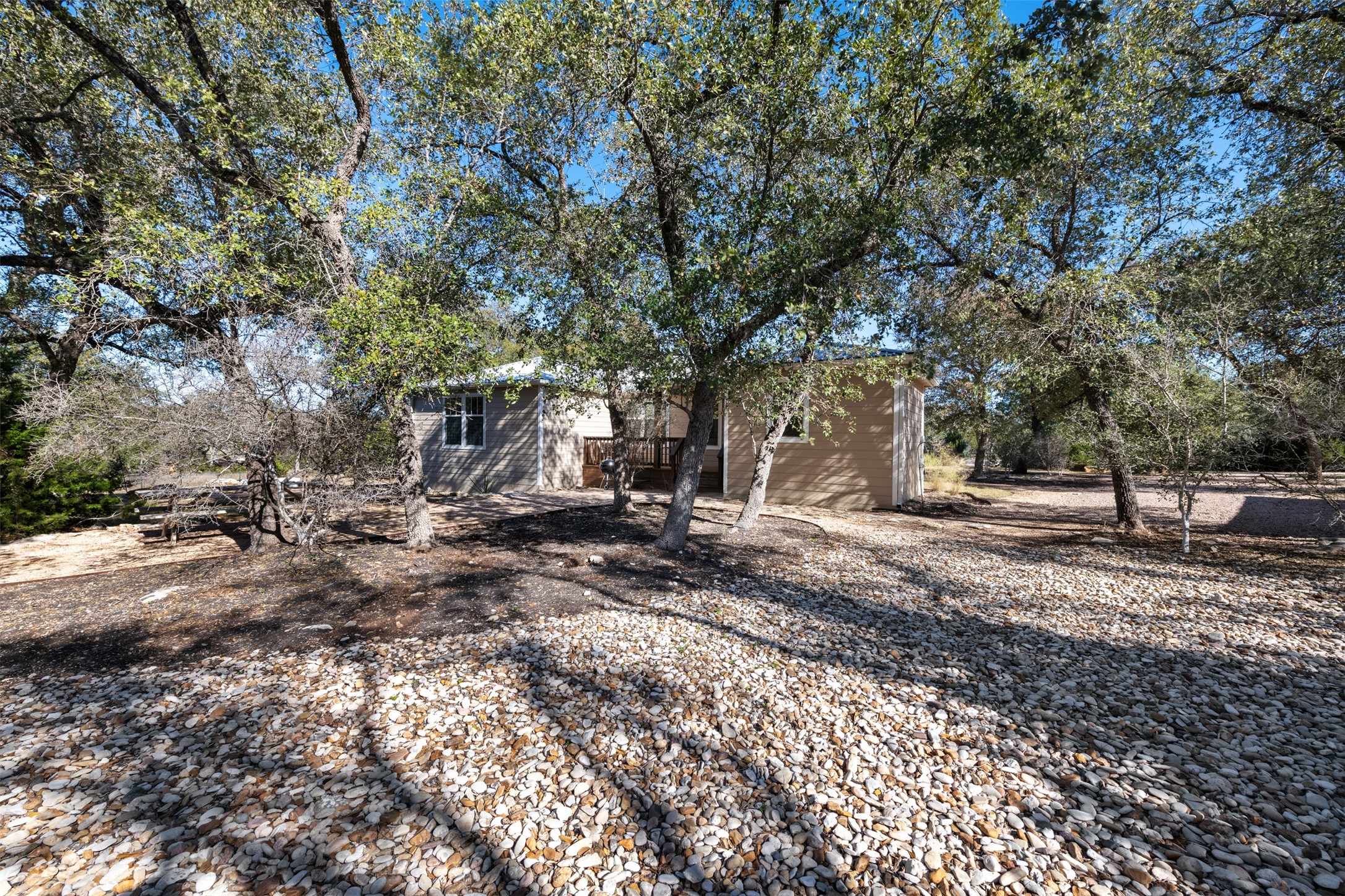 1610 Pace Bend Road North Spicewood, TX 78669 - Photo 27 of 32 a view of a yard with plants and trees