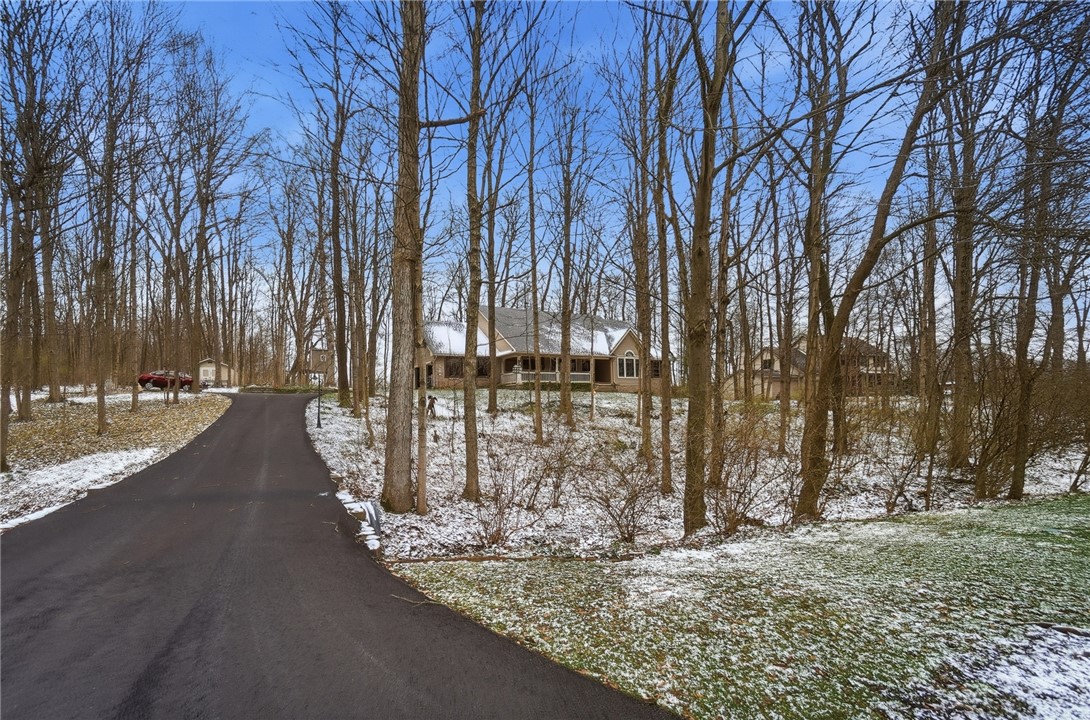 5300 Brookshire Lane Springfield, OH 45502 - Photo 3 of 56 This charming home is nestled amongst mature trees, offering a private and serene setting.