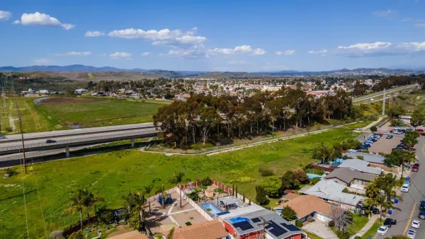 a view of a lake with houses in the background