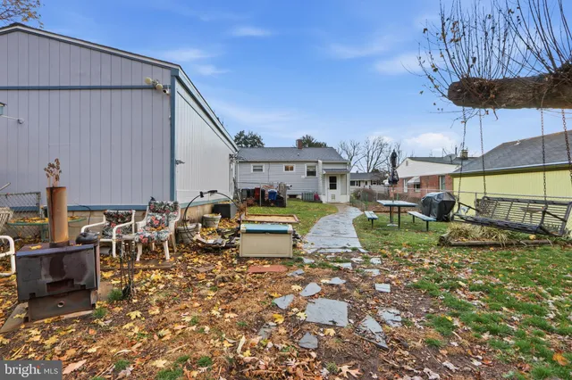 a view of a house with a backyard patio and sitting area